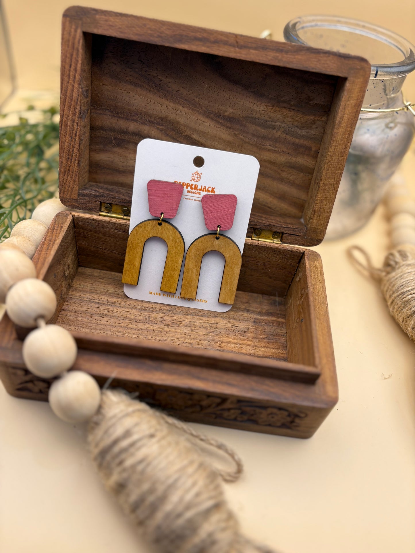 Arch with pink stud earrings