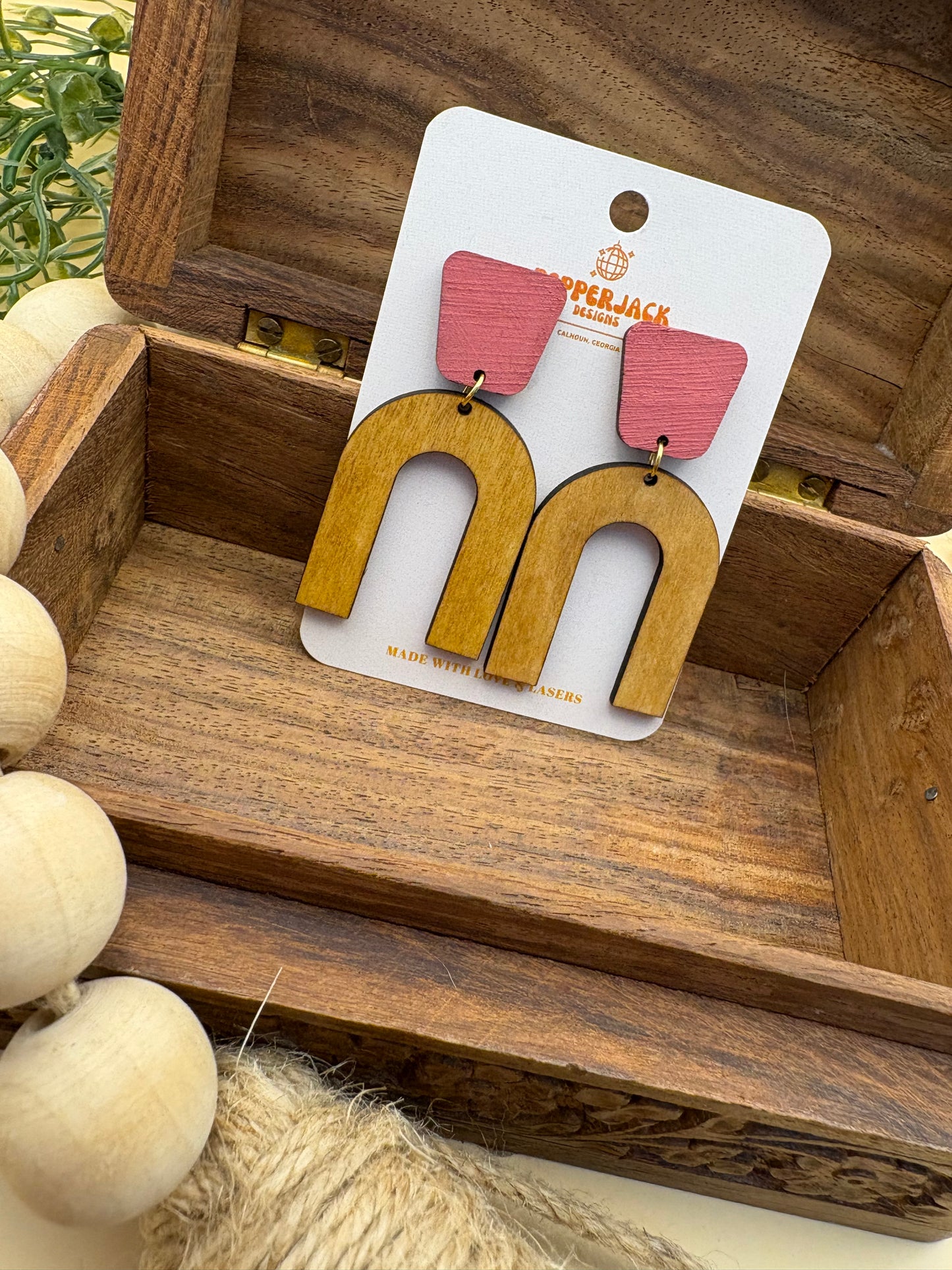 Arch with pink stud earrings